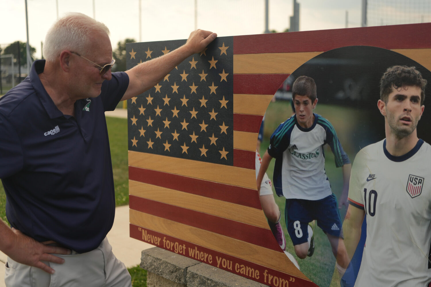 Pennsylvania Classic co-founder and president, Doug Harris, looks at a banner of U.S. national team...