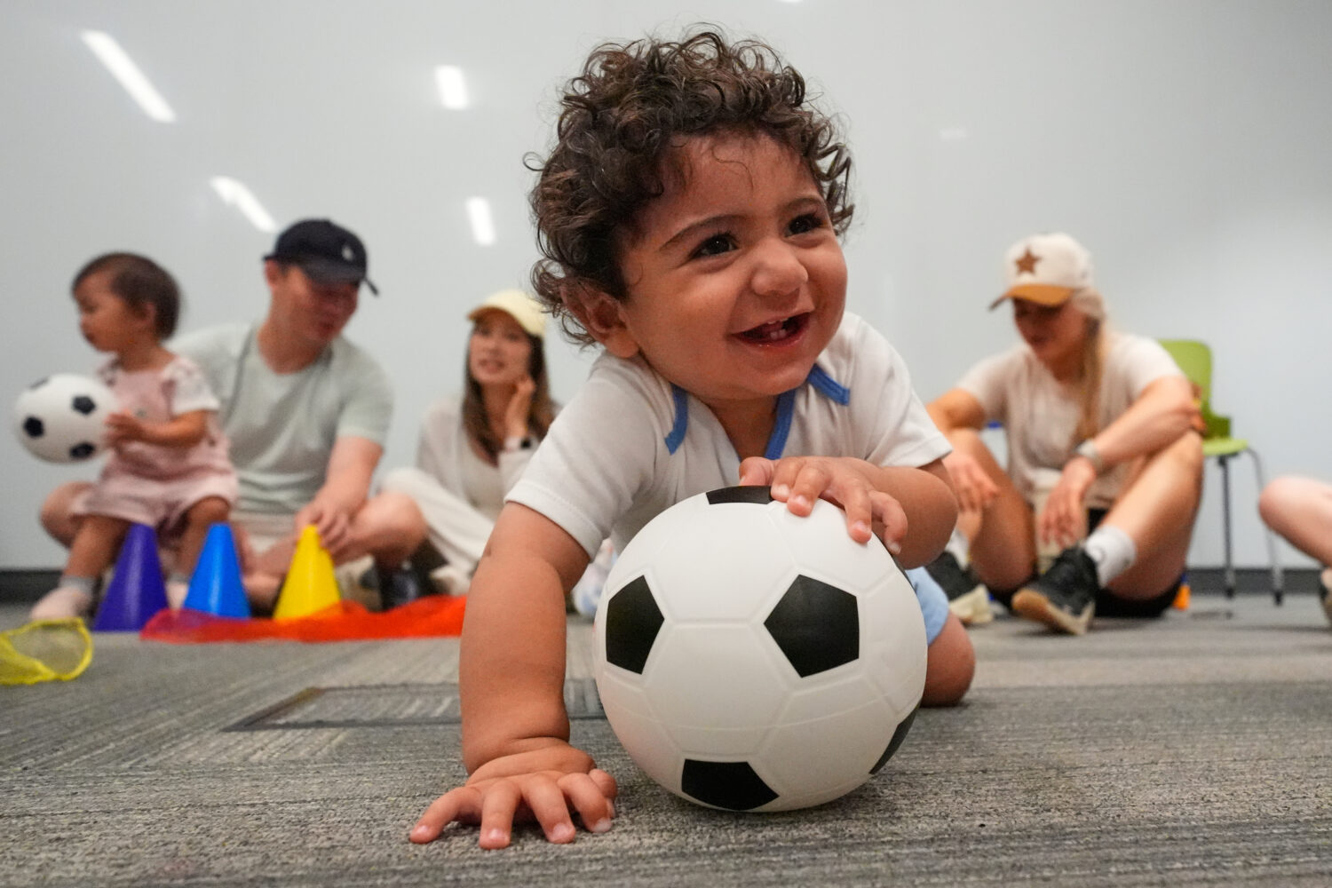 Ten-month-old Zain Fawaz plays with a soccer ball at a program introducing toddlers to the sport ah...