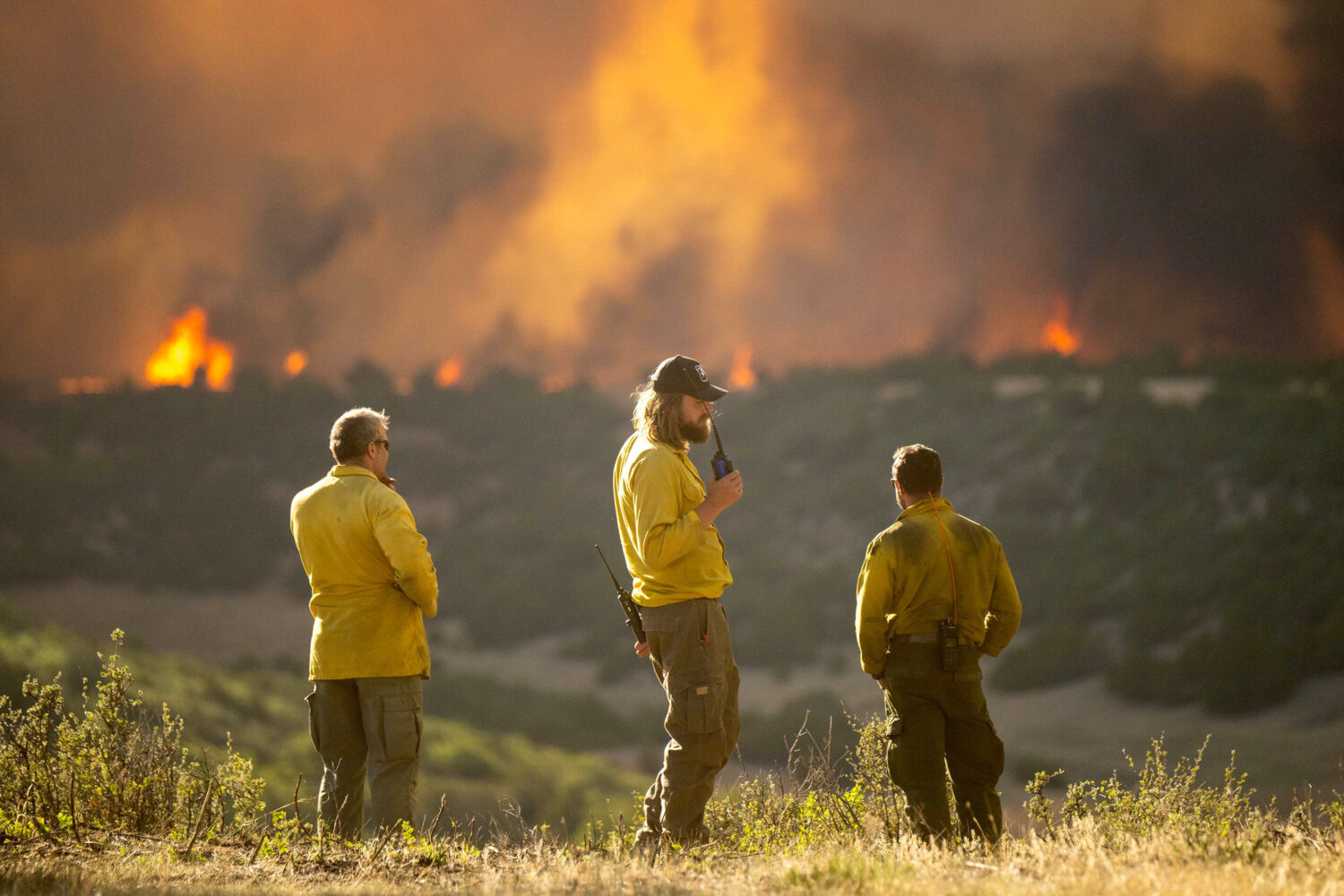 Firefighters monitor the Aspen Acres Fire near Colorado City, Colo., as it begins to grow late on T...