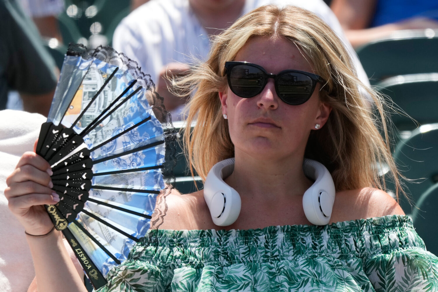 FILE - A baseball fan cools off before a game between the San Diego Padres and the Chicago Cubs in ...