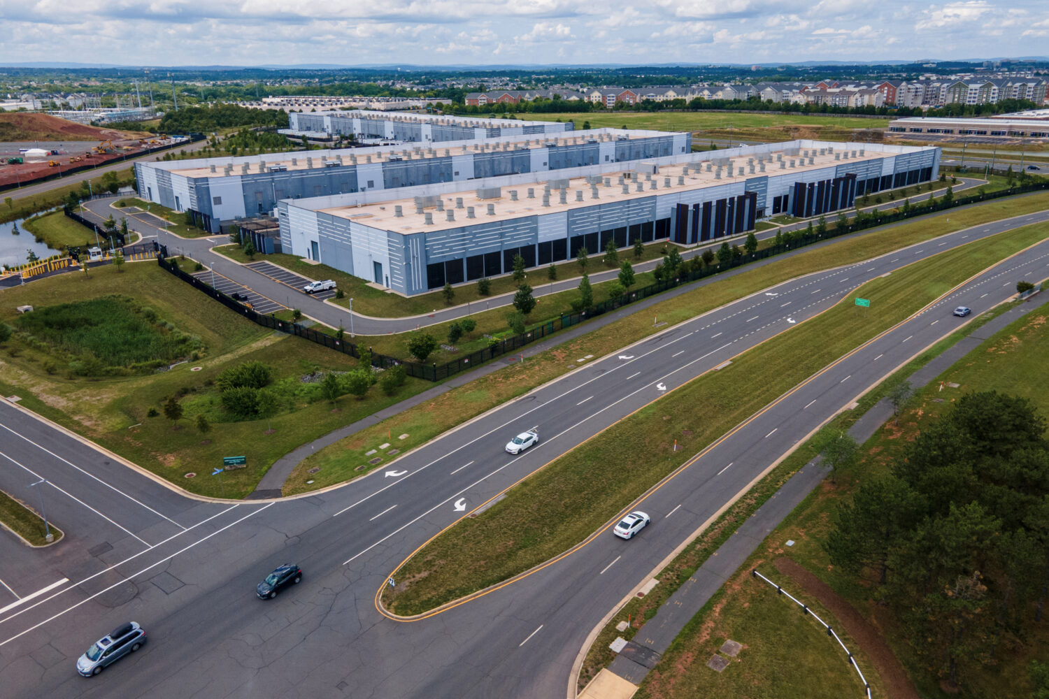 FILE - Cars drive past data centers on July 16, 2023, in Ashburn, Va. (AP Photo/Ted Shaffrey, File)...