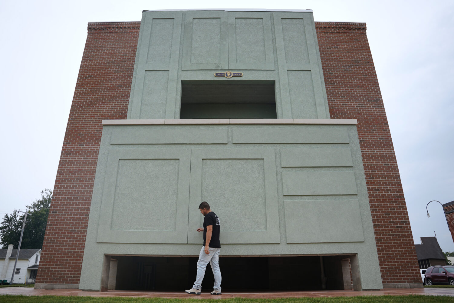 Wesley Mast, owner and president of Coppes Napanee, walks past a giant replica of a Hoosier cabinet...
