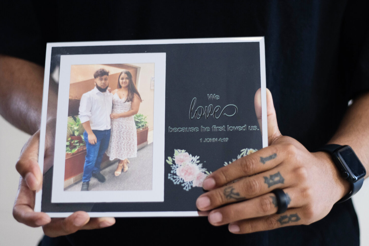 Army Sgt. Hedar Leonel Turcios Juarez holds a picture of himself with with his wife Cristy, who is ...