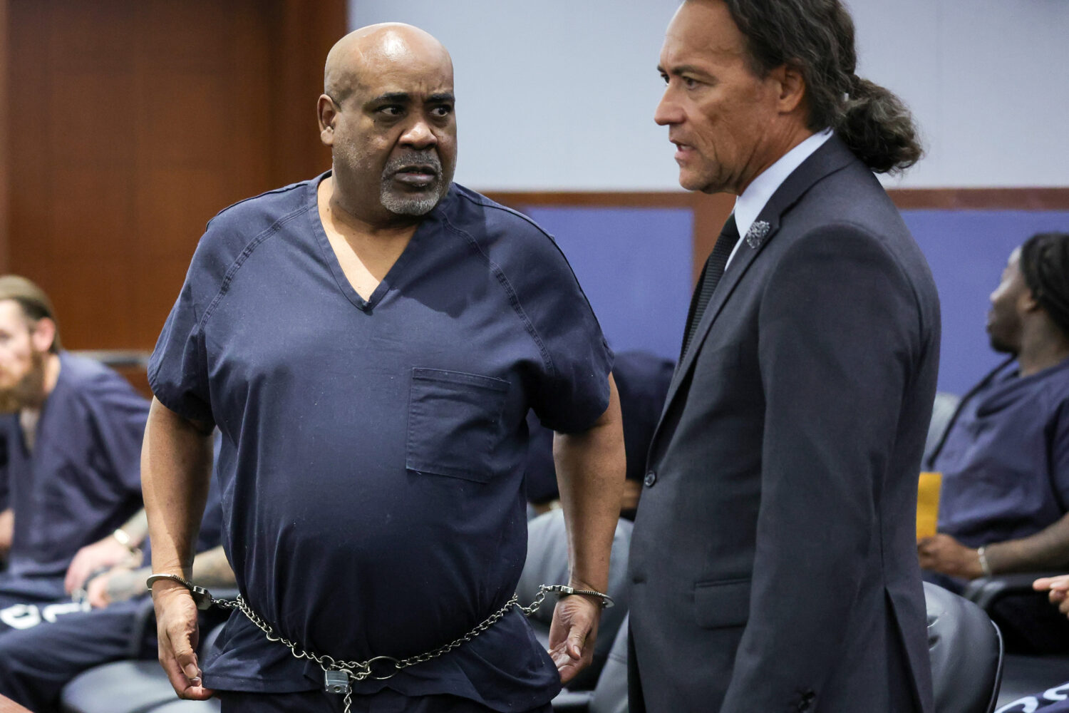 Duane Davis, left, talks with his attorney Michael Sanft in Clark County District Court during a ca...